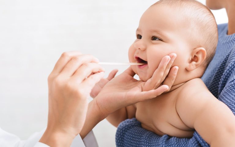 doctor-pediatrician-examining-throat-of-newborn-ba-2022-12-16-07-37-58-utc.jpg